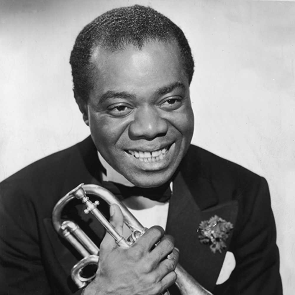 Fotografía en blanco y negro de Louis Armstrong sujetando una trompeta en sus manos